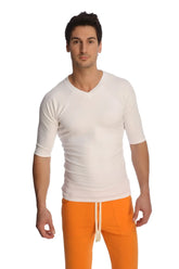 A man wearing a white raglan virtual crew neck shirt with three quarter sleeves and a v neck design