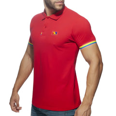 Red men’s polo shirt with rainbow trim on sleeves and a small colorful logo patch on the chest