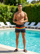 Black mesh swim trunks with a vibrant rainbow stripe across the waistband called rainbow stripe mesh shorts