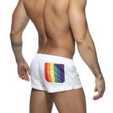 Back side of white rainbow swim short with vibrant rainbow flag patch on the swim trunks pocket