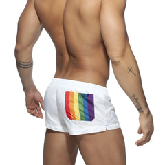 Back side of white rainbow swim short with vibrant rainbow flag patch on the swim trunks pocket