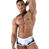 White swim trunks with black and green palm tree print by roberto lucca in size 2xl for beachwear