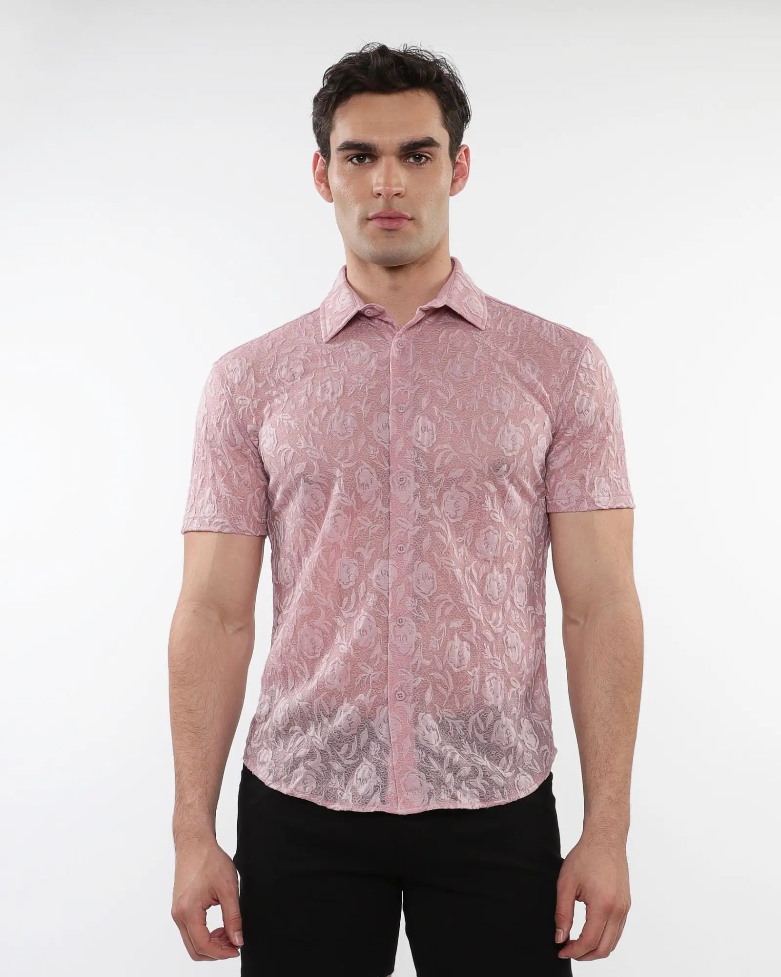 A man wearing a pink roses leaves gossamer knit short-sleeved shirt with an intricate floral lace pattern