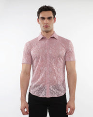 A man wearing a pink roses leaves gossamer knit short-sleeved shirt with an intricate floral lace pattern