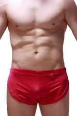 Red satin running shorts joe framboise with smooth shiny finish and small red tag on the waistband
