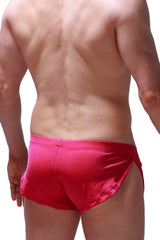 Bright red satin running shorts Joe Framboise with a sleek shiny finish and side slits for enhanced comfort