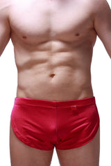 Red satin running shorts joe framboise with smooth shiny finish and small red tag on the waistband