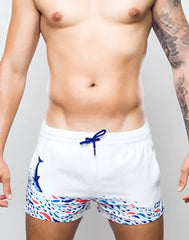 White s50 seascape print swim short featuring blue whale graphic and colorful fish pattern with navy drawstrings