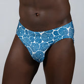 Blue and white patterned swim trunks with circular dotted motifs from the sand dollar brief collection