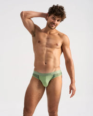 A sleek light green score sheer jock brief with a subtle mesh panel and hmb logo on the waistband