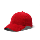 Red corduroy baseball cap with a structured crown and curved brim for casual wear