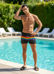 Black mesh swim shorts featuring a vibrant rainbow stripe across the waistband for stylish beachwear