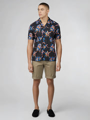 Black short-sleeved button-up shirt with vibrant blue pink and orange floral pattern signature botanical print