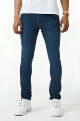 Dark blue skinny fit denim jeans with slim fit, classic five-pocket design, and subtle thigh fading