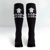 Black knee high socks by Sock It To Me feature a white upward arrow and bad ass text above two stripes size M