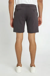 Dark gray solid stretch knit shorts with tailored fit and buttoned back pockets shown from the back side