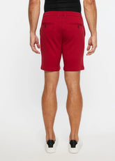 Red men’s solid stretch knit chino shorts with tailored fit and buttoned back pockets showing the back side
