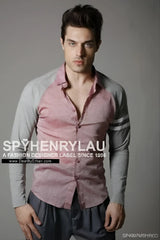 A man wearing a spy henry lau slim fit long sleeved shirt with pink and gray contrast panels in size L