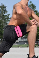 Bright pink running belt with black trim worn by a man in athletic shorts from the ssbag running belt collection