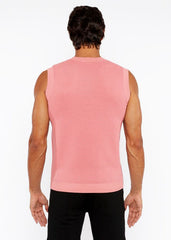 A pink ribbed knit sleeveless top with a crew neckline in a textured open knit vest design
