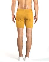 Back view of mustard-yellow st33le stretch knit chino shorts with tailored fit and two back pockets size 29