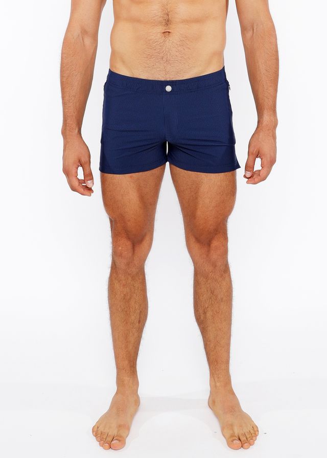 Navy blue pinstripe swim short with white button closure designed for comfortable beachwear