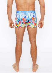 Floral abstract printed swim short featuring vibrant blue orange red and yellow floral pattern for beachwear