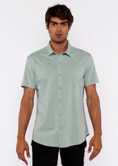 A light green stretch knit shirt with short sleeves classic collar and neatly stitched seams
