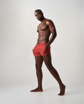 Red statement swim short with elastic waistband made of quick-dry material for athletic use