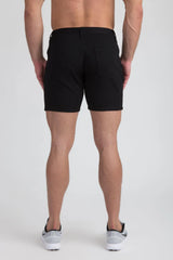 Black stretch knit shorts with tailored fit and two rear pockets shown from the back side