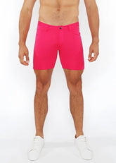 Bright pink stretch knit shorts for men with a clean tailored fit and single button closure
