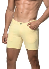 A pair of pale yellow stretch knit shorts with a classic button closure and side pockets in a form-fitting style