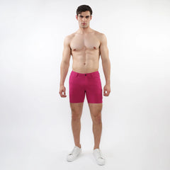 A pair of vibrant fuchsia stretch knit shorts with a form-fitting modern design and subtle stitching details