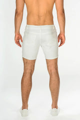 White stretch knit short denim shorts with tailored fit and classic back pockets shown from the back side