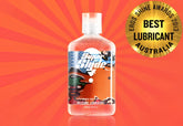 Clear plastic bottle of superslyde silicone lubricant with white cap and colorful cartoon label