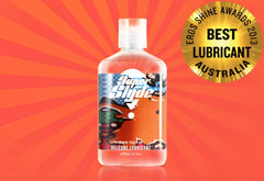 Clear plastic bottle of superslyde silicone lubricant with white cap and colorful cartoon label