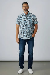 A man wearing a suslo crinkled fabric s/s shirt with an abstract gray and white geometric pattern