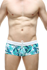 PetitQ swim boxer Macouba men’s swim trunks with white waistband and vibrant teal blue green tropical leaf pattern