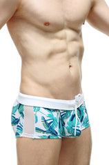 Men’s PetitQ swim boxer Macouba with tropical leaf pattern, white waistband, and mesh side panels for swimming