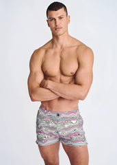 Men’s swirls print seersucker swim shorts with mesh lining featuring vibrant pink green and white abstract waves on gray