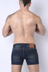 Back side of soma 2.0 denim booty short in dark blue with brown leather patch on waistband made of denim material