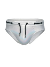 Silver holographic metallic brief swim trunks with black drawstrings and metal eyelets tartarus side track design