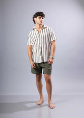 A man wearing a texture knit short-sleeved shirt with vertical black and off-white stripes