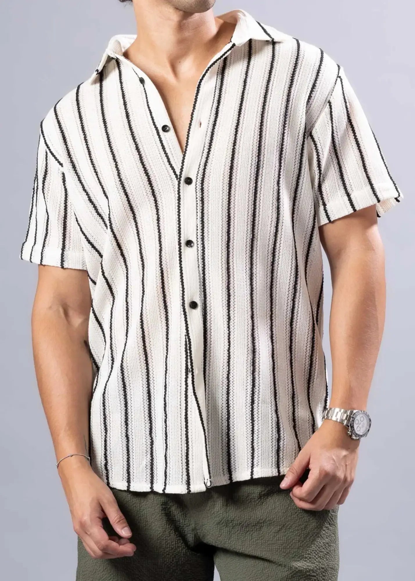 Texture knit short-sleeved button-up shirt with vertical black and cream stripes made of textured fabric