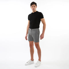 Black short-sleeved polo shirt with classic collar and buttoned placket paired with textured jacquard stretch chino shorts