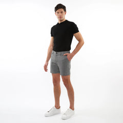 Men’s black short-sleeved polo shirt paired with textured jacquard stretch chino shorts in breathable fabric