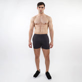 Black textured mesh stretch performance shorts with sleek form-fitting design and elastic waistband for athletics
