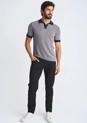 A man wearing a textured stripes silk tencel polo shirt in navy and gray with a dark blue collar cuffs and hem