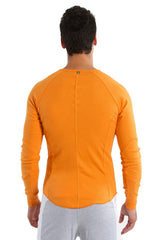Thermal v-neck long sleeve in sun orange with ribbed back panel and raglan sleeves for athletic wear shown from back