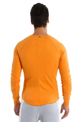 Thermal v-neck long sleeve in sun orange with ribbed back panel and raglan sleeves for athletic wear shown from back